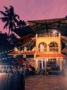 a building with lights in front of it at night at Kulture KonnectT Kurakanni in Varkala