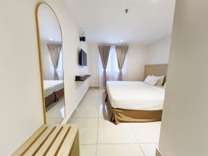 a hotel room with a bed and a mirror at Living At DSulaiman Hotel in Kuala Lumpur