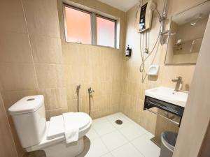 a bathroom with a toilet and a sink at Living At DSulaiman Hotel in Kuala Lumpur +14 photos