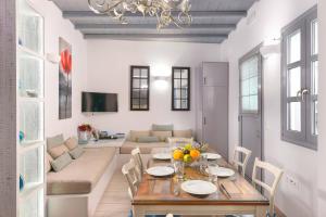 a dining room with a table and a living room at Lindos Shore Boutique Villa with sea view in Líndos