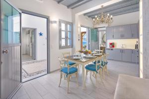 a kitchen and dining room with a table and chairs at Lindos Shore Boutique Villa with sea view in Lindos