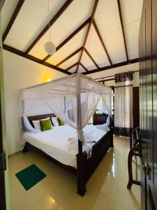 a large bed with a canopy in a room at Suzzi Villa in Weligama +107 photos