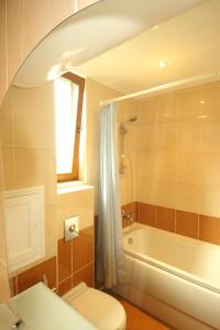 a bathroom with a toilet and a tub and a sink at Menada Midia Apartments in Sunny Beach +57 photos