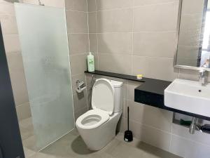 a bathroom with a white toilet and a sink at Tropicana 218 Macalister in George Town +84 photos