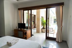 TV a/nebo společenská místnost v ubytování The Daun Bali