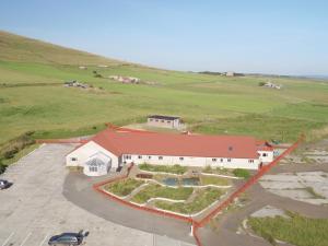 an aerial view of a white building with a red roof at Orkneylodge in Orphir