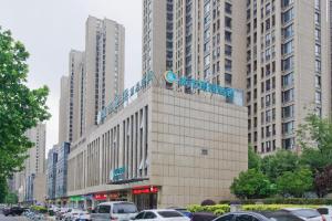 a large building with a sign on top of it at City Comfort Inn Hefei Binhu Wanda Plaza in Hefei