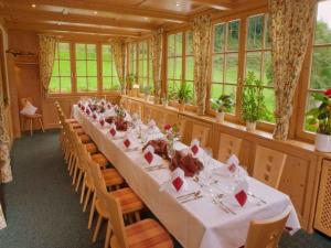 a dining room with a long table and chairs at Gasthaus Hohberg in Durbach