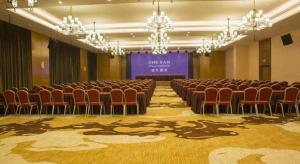 a large room with chairs and a stage in it at James Joyce Coffetel· Changde Liuyehu in Changde