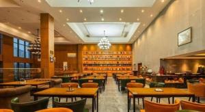 a restaurant with tables and chairs and a bar at James Joyce Coffetel· Changde Liuyehu in Changde