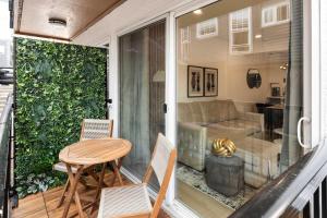 a screened in porch with a table and chairs at Brand New 2BR Queen Anne Condo Designer's Taste in Seattle