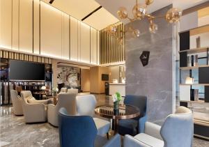 a hotel lobby with a table and chairs at Echarm Hotel Shenyang Zhongjie North Station Metro Station in Shenyang