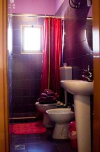 a bathroom with a sink and a toilet and a window at Casa Augusta in Bibione