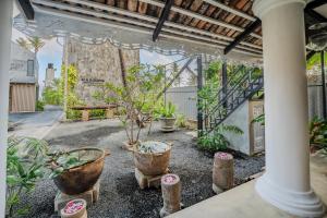 a courtyard with potted plants in a building at Secret Beach Ahangama in Ahangama