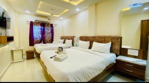 Ένα ή περισσότερα κρεβάτια σε δωμάτιο στο hotel saffron