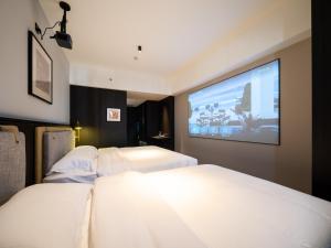 Ліжко або ліжка в номері Xi'an Firefly Hotel