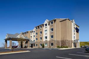 a large building on the side of a street at Microtel Inn & Suites by Wyndham Wheeling at The Highlands in Triadelphia