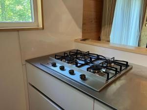 a stove top oven sitting on top of a kitchen counter at Asu base Yuge in Hachimantai