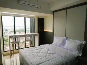 Ένα ή περισσότερα κρεβάτια σε δωμάτιο στο Pollux Habibie Apartment Batam +59 φωτογραφίες