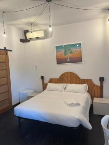a bedroom with a large bed with white sheets at La Locanda della Mandria 1 in Venaria Reale