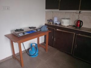 a kitchen with a table with a stove on it at BG Guest House Jaffna in Tirunelveli East +15 photos