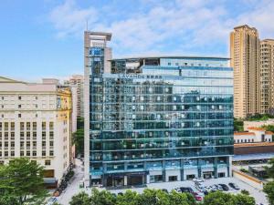 a large glass building in a city with buildings at Lavande Hotel Dongguan City Hall Guomao in Dongguan