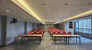 a conference room with red chairs and tables in a building at Borrman Hotel Guilin North Railway Station Zhonghao International in Lingchuan