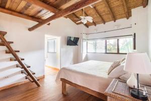a bedroom with a bed and a wooden ceiling at Toro by Dreamcatcher in Santa Teresa Beach