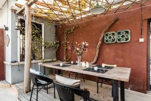 a wooden table and chairs on a patio at Origin Antique House and Hotel in Guangzhou