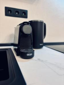 a phone sitting on a counter next to a coffee cup at Casuta cu ciubar Valea Avrigului - Secret Forest in Avrig