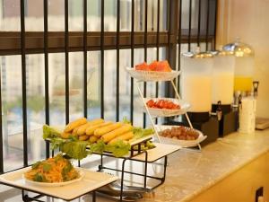 a buffet with three tiers of food on a counter at GreenTree Inn Express Kunming East Passenger Station Huazhicheng in Kunming