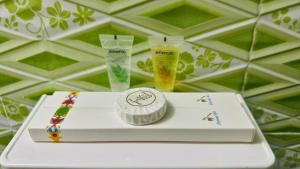 a white table with two cups and a box at Hotel Blue Sky Mirpur in Dhaka