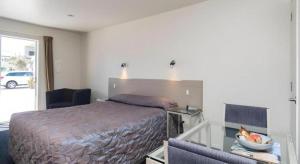 Ένα ή περισσότερα κρεβάτια σε δωμάτιο στο Hawera Central Motor Lodge +163 φωτογραφίες