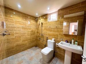 a bathroom with a toilet and a sink and a shower at Krautergarten Resort & Wellness in Negombo +50 photos