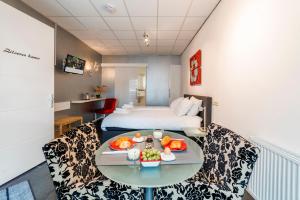 pokój hotelowy z łóżkiem i stołem z jedzeniem w obiekcie B&B Groene Meent w mieście Leerdam