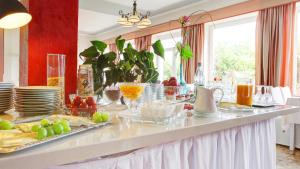 a breakfast table with plates and bowls of food at Hotel Rhein-Residenz in Bad Breisig