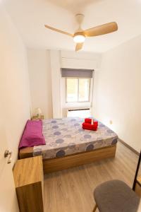 Apartament with balcony في مدريد: غرفة نوم بها سرير ومروحة سقف