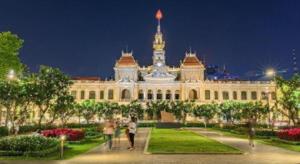 people walking in front of a building at night at Ha Oanh Hotel in Ho Chi Minh City