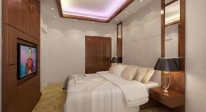 a bedroom with a large white bed in a room at Draco - Thang Long Hotel in Hai Phong