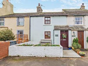 a white house with a garden in front of it at 2 Bed in Ravenglass 95884 in Ravenglass