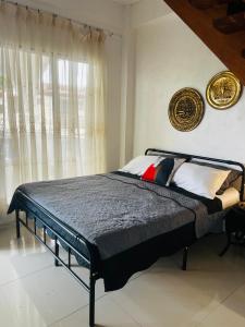 a bedroom with a bed and a window at Anton & Isabel Charming Home in Bangued in Bangued