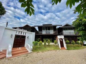 a large house with white walls and brown doors at The White House Boutique Resort in Ban Pang Mung +282 photos