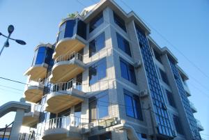 a building with balconies on the side of it at Best Point Hotel in Dar es Salaam