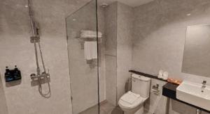 a bathroom with a shower and a toilet and a sink at Butterfly Princess Hotel in Ban Komo Sip Paet +52 photos