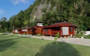 a group of cabins in front of a mountain at Phuphayot Resort in Huai Yot
