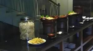 a buffet of food on a table with plates of food at Hotel Adilla Syariah Ambarukmo in Yogyakarta