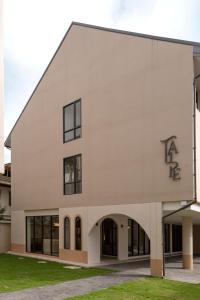 a white building with the letters fa on it at Taupe Hotel in Chiang Mai
