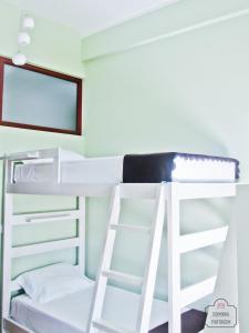 a bunk bed with a ladder in a room at Coimbra Portagem Hostel in Coimbra