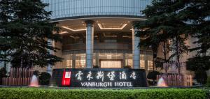 a building with a sign in front of it at Vanburgh Hotel Guangzhou in Guangzhou +56 photos