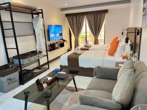 a bedroom with a bed and a couch and a tv at 88th Avenue in Cebu City